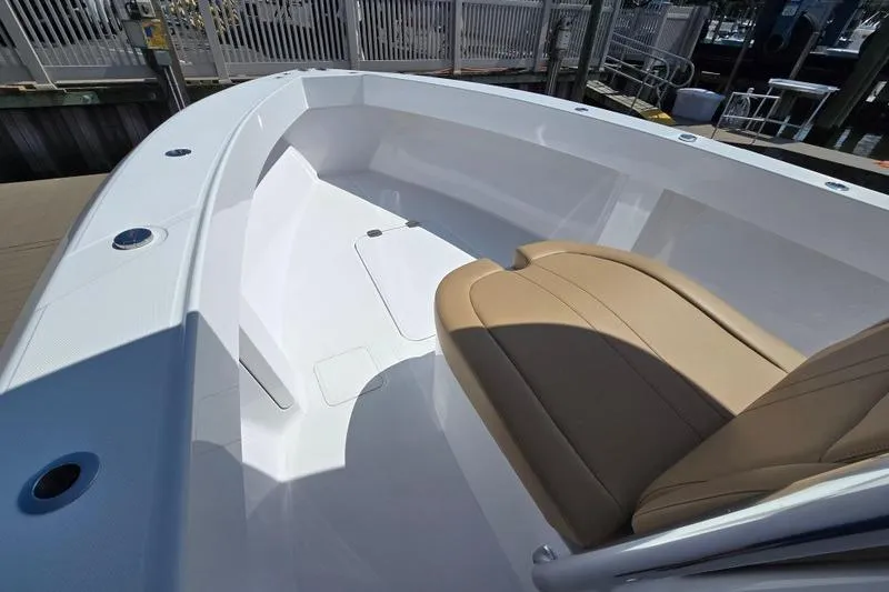 Slide: The Image of 2025 Bahama 35 boat interior with tan seating and sleek white design. - 4