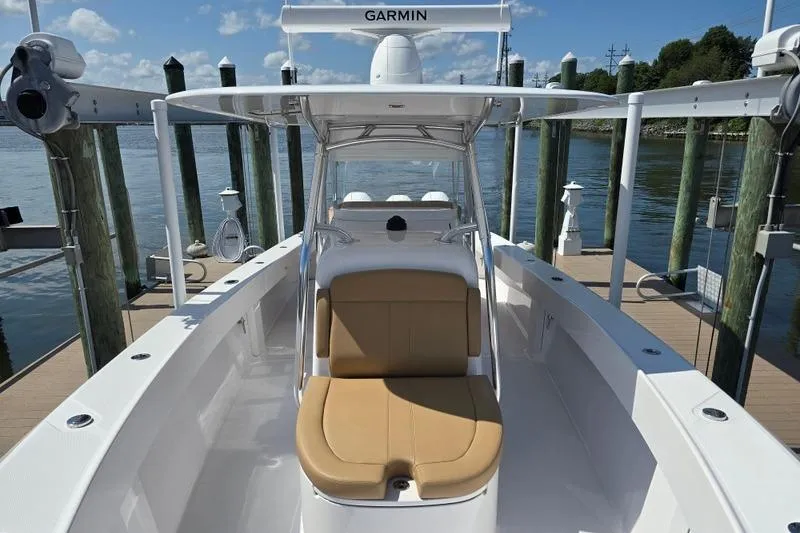 Slide: The Image of 2025 Bahama 35 boat with tan seating, docked by the water, featuring Garmin equipment. - 5