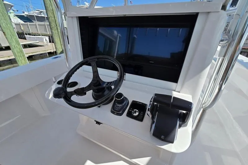 Slide: The Image of 2025 Bahama 35 boat helm with steering wheel and control panel. - 6