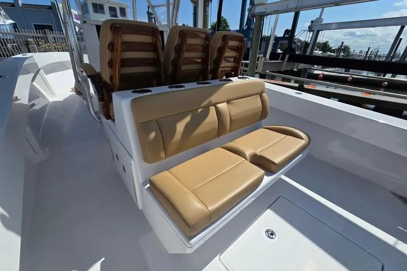 Slide: The Image of 2025 Bahama 35 boat with tan leather seating and sleek white deck design. - 7