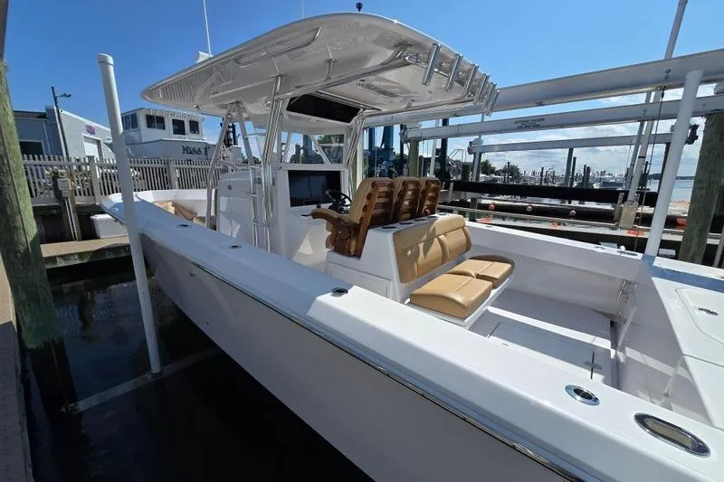Slide: The Image of 2025 Bahama 35 boat docked, featuring sleek design and comfortable seating. - 8