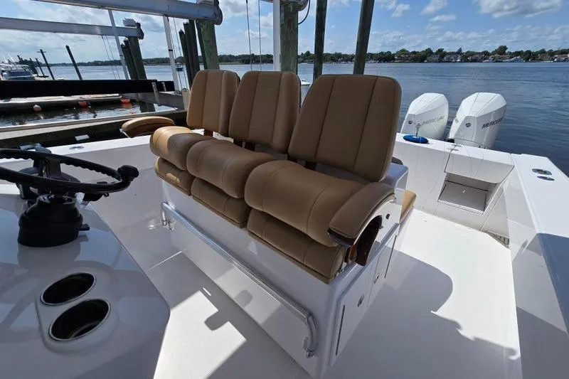 Slide: The Image of 2025 Bahama 35 boat interior with tan seating and dual outboard motors. - 9