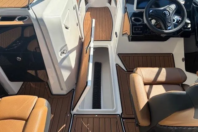 Slide: The Image of 2026 Yamaha Boats 252SD interior with tan seats and wood-style flooring. - 14