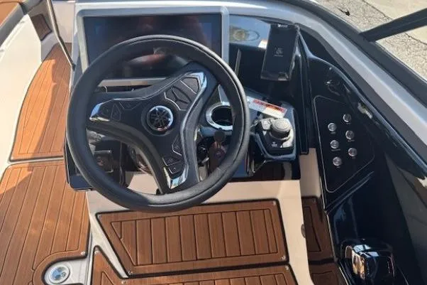 Slide: The Image of 2026 Yamaha Boats 252SD steering console with modern controls and wood accents. - 17