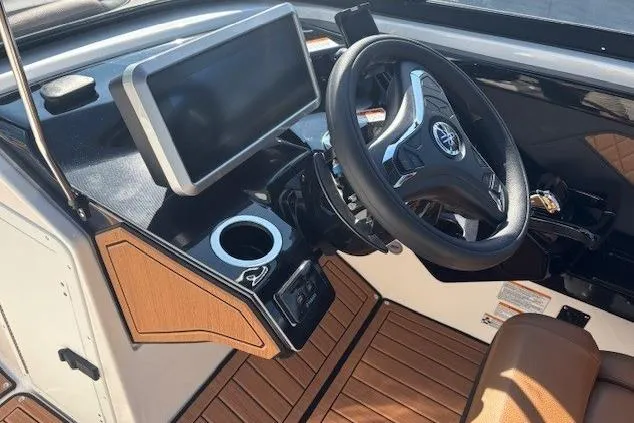 Slide: The Image of 2026 Yamaha Boats 252SD dashboard with steering wheel and touchscreen display. - 18