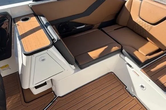 Slide: The Image of 2026 Yamaha Boats 252SD interior with brown seating and wood-style flooring. - 22