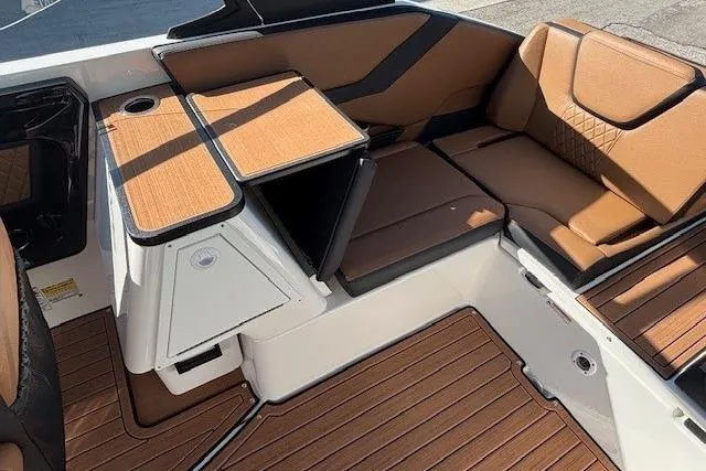 Slide: The Image of 2026 Yamaha Boats 252SD interior with brown seating and wood accents. - 23