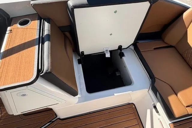 Slide: The Image of 2026 Yamaha Boats 252SD interior seating with storage compartment open. - 24