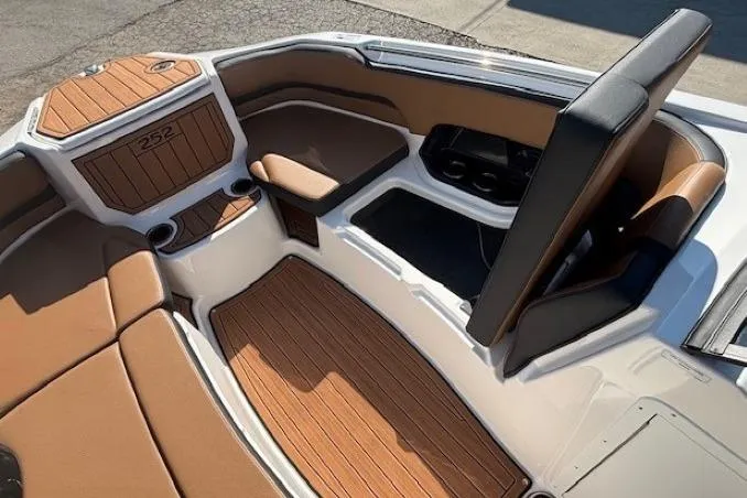 Slide: The Image of 2026 Yamaha Boats 252SD interior with tan seating and wood accents. - 9