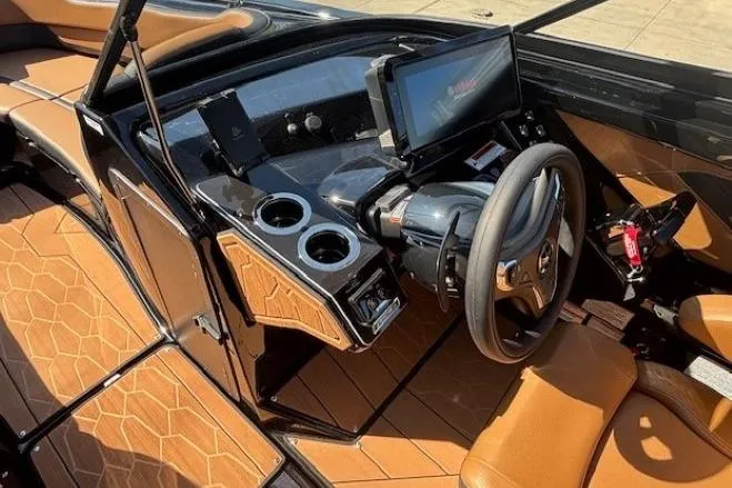 Slide: The Image of 2026 Yamaha Boats 255XD interior with modern dashboard, steering wheel, and tan seating. - 12