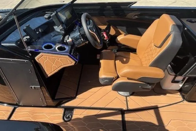 Slide: The Image of 2026 Yamaha Boats 255XD cockpit with tan seating, modern dashboard, and steering wheel. - 14
