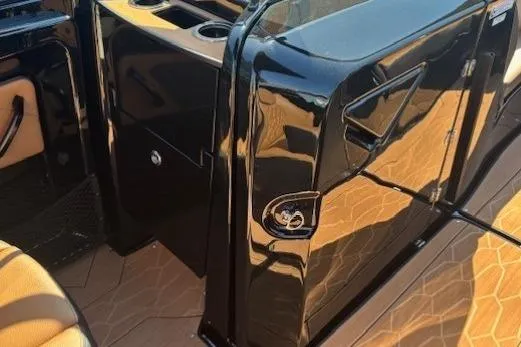 Slide: The Image of Interior view of 2026 Yamaha Boats 255XD, featuring sleek black design and tan seating. - 16