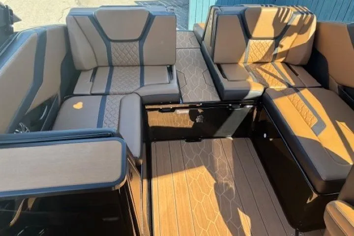 Slide: The Image of 2026 Yamaha Boats 255XD interior with tan and black seating, showcasing modern design and comfort. - 21