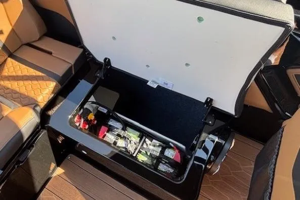 Slide: The Image of Open storage compartment in 2026 Yamaha Boats 255XD, showcasing organized interior space. - 22