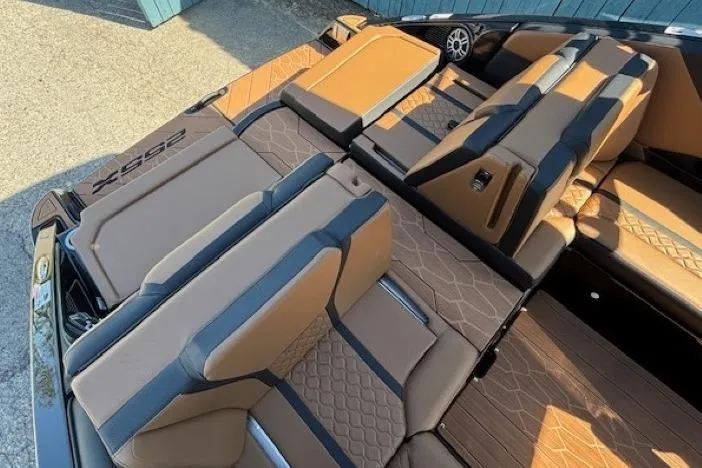 Slide: The Image of 2026 Yamaha Boats 255XD interior with tan and black seating, showcasing luxury and comfort. - 30