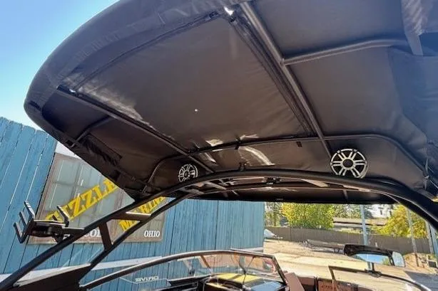 Slide: The Image of 2026 Yamaha Boats 255XD with canopy and speakers, outdoor setting. - 31