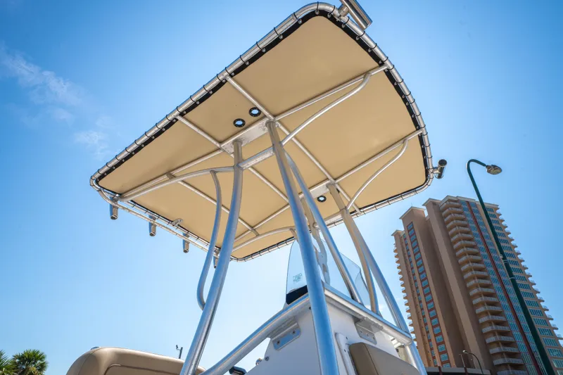 Slide: The Image of 2016 Sportsman Masters 207 Bay Boat with T-top against a cityscape background. - 10