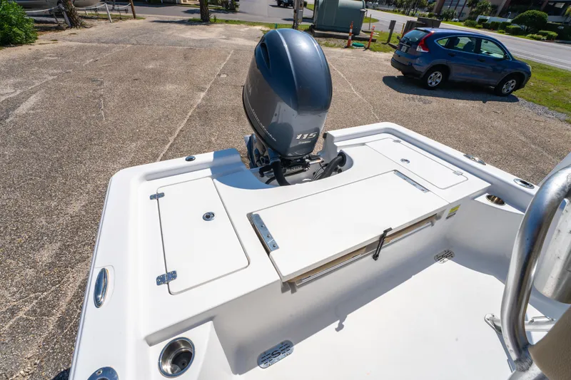 Slide: The Image of 2016 Sportsman Masters 207 Bay Boat with outboard motor in a parking area. - 11