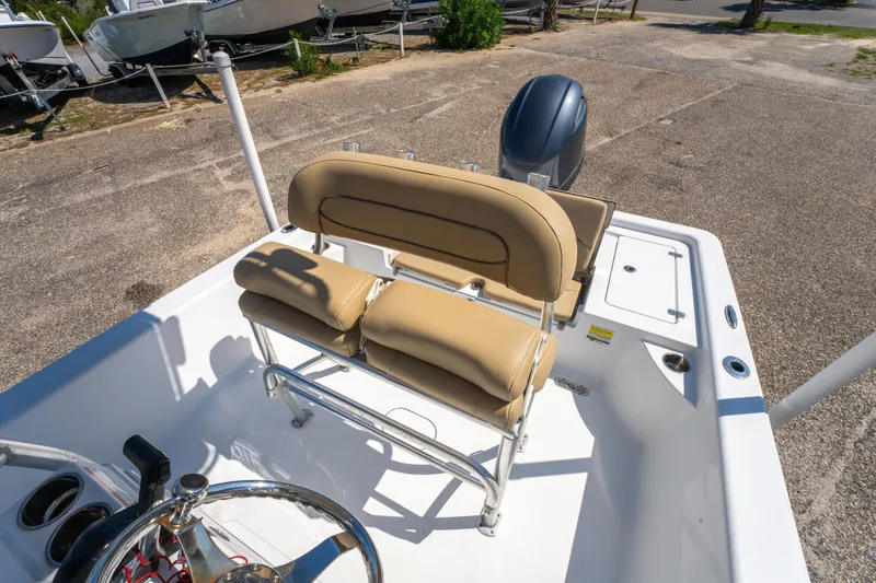 Slide: The Image of 2016 Sportsman Masters 207 Bay Boat interior with tan seating and steering wheel. - 13