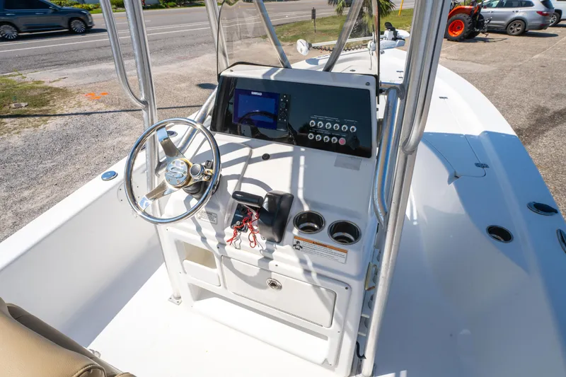 Slide: The Image of 2016 Sportsman Masters 207 Bay Boat console with steering wheel and navigation display. - 15