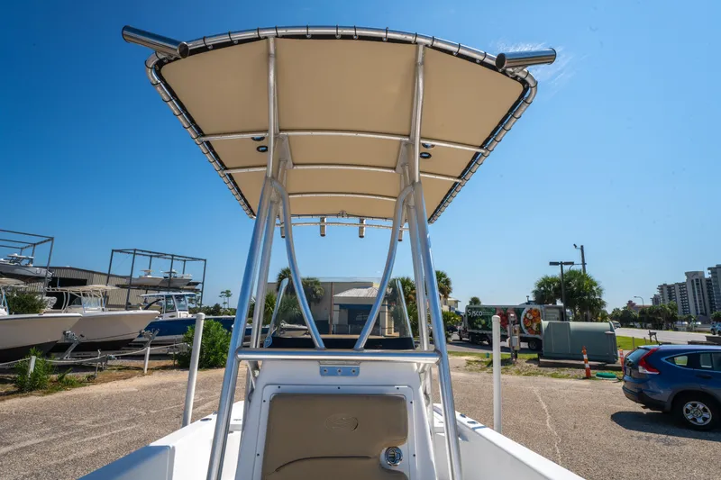 Slide: The Image of 2016 Sportsman Masters 207 Bay Boat with T-top in a parking lot. - 21