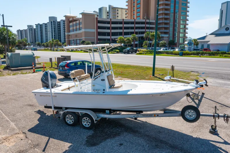 Slide: The Image of 2016 Sportsman Masters 207 Bay Boat on trailer, urban background, sunny day. - 23