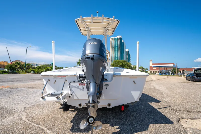 Slide: The Image of 2016 Sportsman Masters 207 Bay Boat with outboard motor, parked on a sunny day. - 5