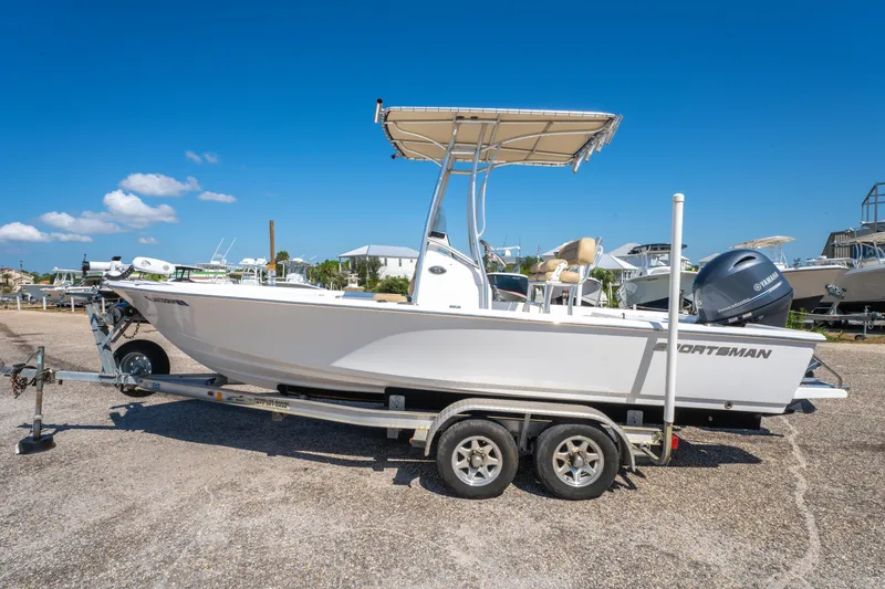 Slide: The Image of 2016 Sportsman Masters 207 Bay Boat on trailer under clear blue sky. - 7