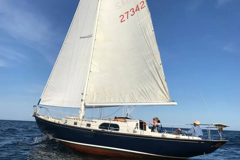 The Image of Sailing on a 1957 Rhodes Bounty yacht under clear blue skies. - 0
