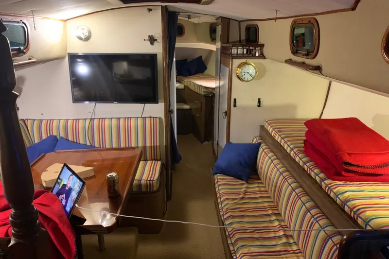 Slide: The Image of Interior of a 1957 Rhodes Bounty sailboat with striped seating and modern amenities. - 15