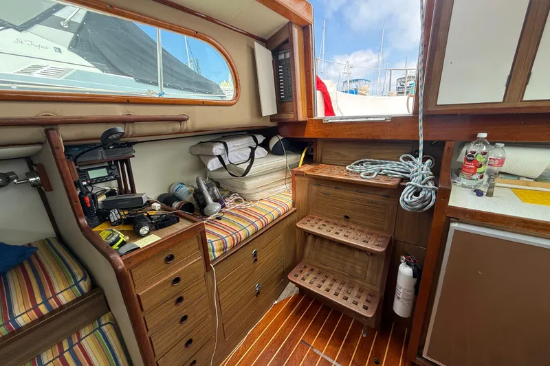 Slide: The Image of 1957 Rhodes Bounty boat interior with wooden cabinetry and nautical equipment. - 17