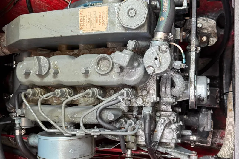 Slide: The Image of 1957 Rhodes Bounty engine close-up, showcasing mechanical components and Universal Motors label. - 24