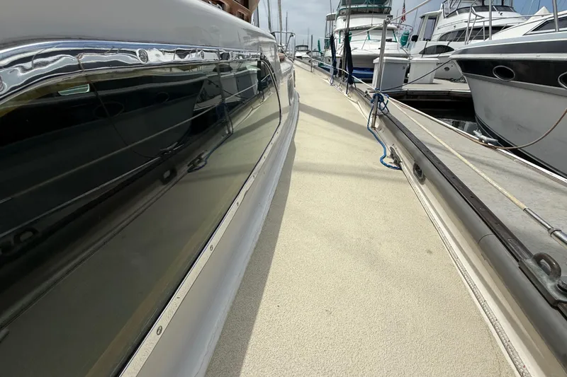 Slide: The Image of 1957 Rhodes Bounty yacht docked at marina, showcasing sleek design and polished exterior. - 8