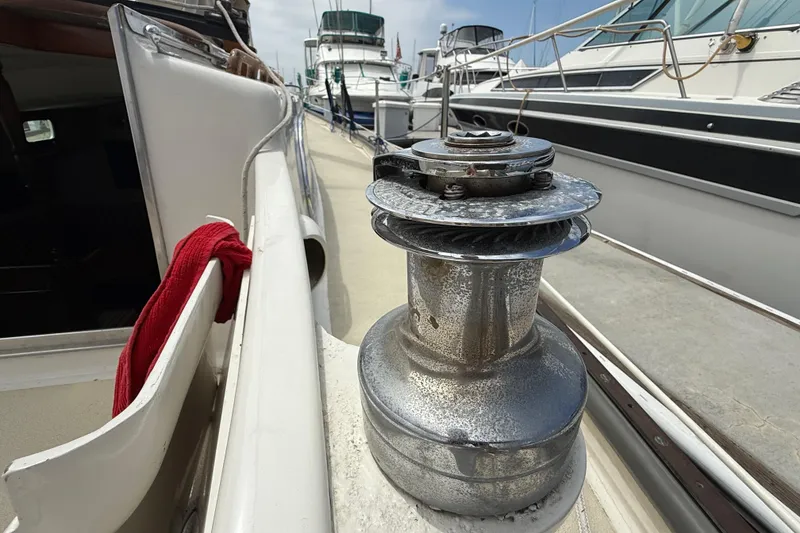 Slide: The Image of 1957 Rhodes Bounty sailboat deck with winch and red cloth. - 9