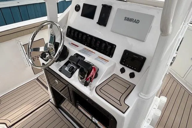 Slide: The Image of 2026 Yamaha Boats 222 FSH Sport E dashboard with Simrad electronics and steering wheel. - 12