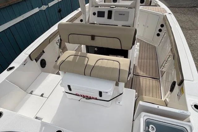 Slide: The Image of 2026 Yamaha Boats 222 FSH Sport E interior with beige seating and modern console. - 13