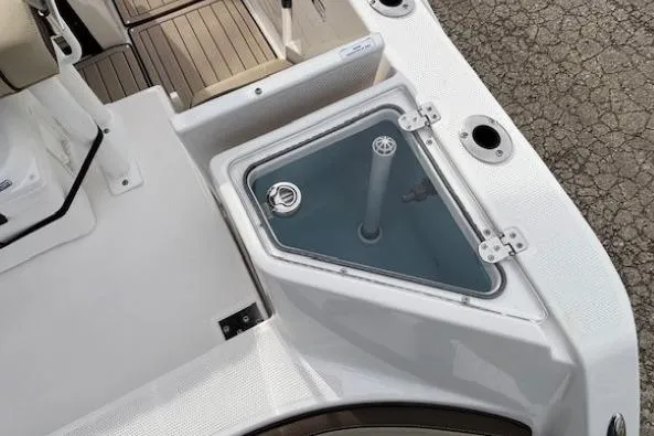 Slide: The Image of 2026 Yamaha Boats 222 FSH Sport E deck with storage compartment and seating area. - 14