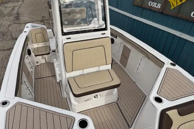 Slide: The Image of 2026 Yamaha Boats 222 FSH Sport E interior with beige seating and sleek design. - 8