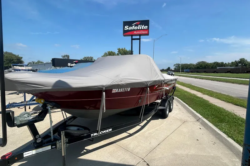 Slide: The Image of 2016 Tracker Targa V-18 Combo boat covered on trailer near Safelite AutoGlass sign. - 10
