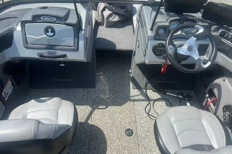 Slide: The Image of 2016 Tracker Targa V-18 Combo boat interior with steering wheel and seating. - 13