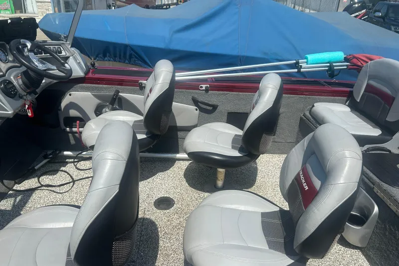 Slide: The Image of 2016 Tracker Targa V-18 Combo boat interior with gray seating and steering console. - 15