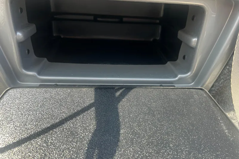 Slide: The Image of Storage compartment of a 2016 Tracker Targa V-18 Combo boat, open and empty. - 16