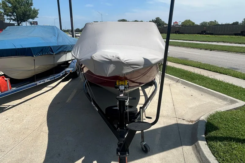 Slide: The Image of 2016 Tracker Targa V-18 Combo boat covered and parked on a trailer. - 6