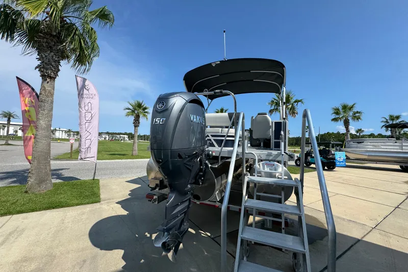 Slide: The Image of 2026 Bennington 22 SSB boat with Yamaha 150 engine, displayed outdoors under clear sky. - 13