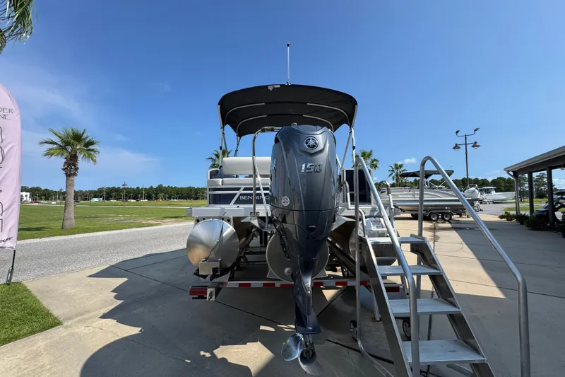 Slide: The Image of 2026 Bennington 22 SSB pontoon boat with Yamaha 150 engine, parked outdoors. - 14