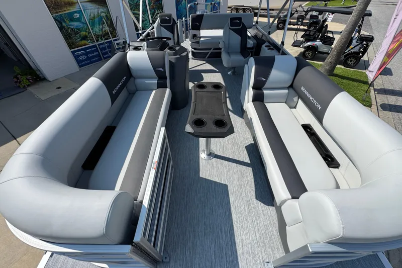 Slide: The Image of 2026 Bennington 22 SSB pontoon boat interior with plush seating and central table. - 18