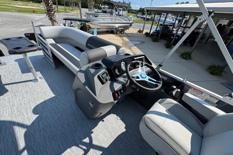 Slide: The Image of 2026 Bennington 22 SSB pontoon boat interior with steering console and seating. - 26