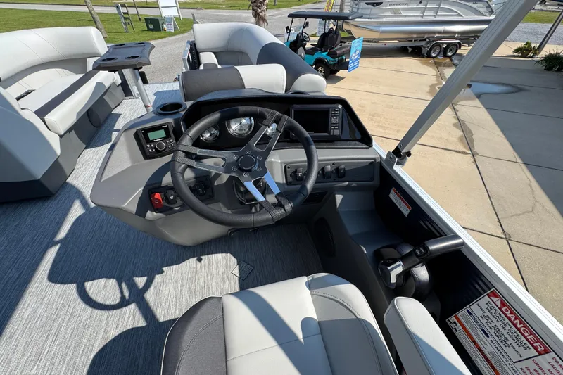 Slide: The Image of 2026 Bennington 22 SSB boat interior with steering wheel and seating area. - 27