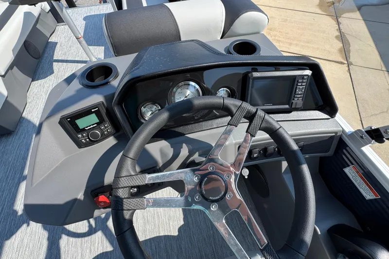 Slide: The Image of 2026 Bennington 22 SSB boat dashboard with steering wheel, gauges, and navigation system. - 29