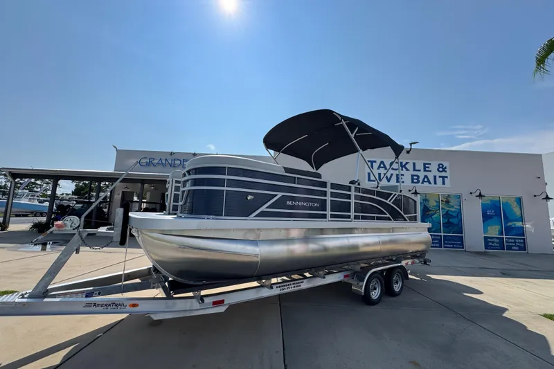 Slide: The Image of 2026 Bennington 22 SSB pontoon boat on trailer outside tackle shop. - 3